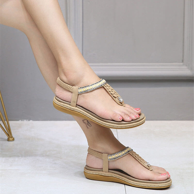 Stylish flat gladiator sandals with crystal detailing, PU upper, and elastic band. Comfortable for women, featuring a floral pattern.